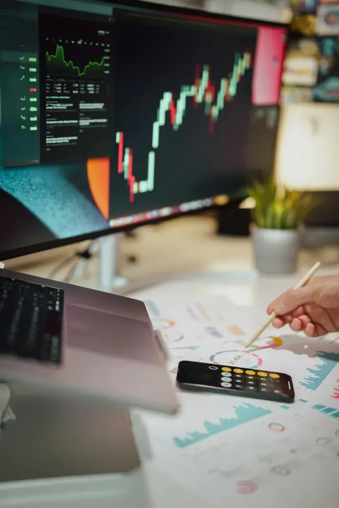Screen with data, papers with graphs and calculator